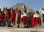 We're alive! Students in Taiwan jump together in front of a mock pyramid after the countdown time when many believe the Mayan people predicted the end of the world