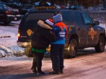 Grief: Loved ones of LeTroy Edwards and Selena Carranza console each other after police said the couple and Carranza's 11-year-old son have died from accidental carbon monoxide poisoning