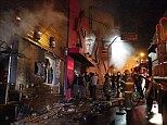 Appaliling loss of life: Firefighters work to douse a fire at the Kiss Club in Santa Maria city, Rio Grande do Sul state, Brazil, where hundreds of people died 