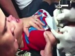 Sickening: A mother holds down her toddler son as he screams in agony while being given a tattoo