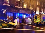 Horror: Paramedics fought to save the man after he was hit by a sign from a William Hill shop, pictured, in Camden, north London