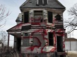Ghost town: A vacant and blighted home, covered with red spray paint, sits alone in an east side neighborhood once full of homes in Detroit