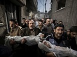 First Place: Henson's picture shows a group of men marching the dead bodies through a narrow street in Gaza City. The victims, a brother and sister, are wrapped in white cloth with only their faces showing