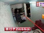 Tight squeeze: A Tokyo local shows a Japanese news crew around her tiny 'coffin apartment' 