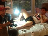 Laid-back Lionel: Messi puts his feet up as the tattooist begins work on the Barcelona superstar's left leg 