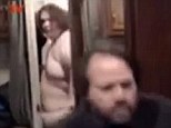 This grainy grab from the clip shows Westboro Baptist Church member David Phelps (foreground) being interviewed in a mobile studio as a 35-stone man, who was wearing no clothes, suddenly burst out of a loo to confront him