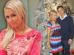 Showing off her favourite Christmas toy(boy)! Paris Hilton poses with beau next to tree