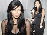 Busting out a tune! Kim Kardashian sings karaoke as she shows off her pregnancy curves in a revealing dress at Ivory Coast nightclub