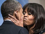 Four more years: Michelle Obama kisses Barack as the couple attend a celebration for their supporters in D.C. on Sunday night 