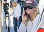 Time to hang it up! Reese Witherspoon caught talking on her cell phone while pumping gas... which could pose fire threat