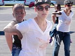 'Get comfortable!' Jillian Michaels totes her daughter Lukensia on her back... during family day at Malibu Farmers Market