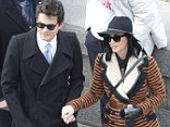 Star in stripes: Katy looked pared down in her brown and black striped coat and hat, while Mayer sported a black wool coat over a shirt and tie