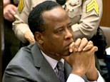 Stuck in the middle: Conrad Murray's two lawyers had a physical altercation when they visited him at LA county jail today, sources said