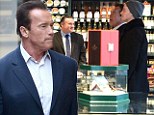 Well, Arnie is in the Big Smoke!: Schwarzenegger and his son Patrick shop for cigars as they enjoy a day out in London