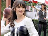 Touchdown! Zooey Deschanel gets to grips with an American football on set of New Girl