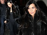 Time to invest in some maternity clothes? Pregnant Kim Kardashian pairs her chic fur coat with... jogging bottoms