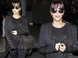 Over exposure! Kim Kardashian accidentally flashes her black bra after her top turns see-through under camera lights