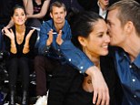 Can't get closer than this! A beaming Olivia Munn gets hugs and kisses from boyfriend Joel Kinnaman at Lakers game