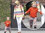 Keep up mommy! January Jones's one-year-old son Xander races ahead of her... as they step out in bold coordinating coloured stripes 