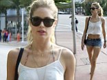 Keeping it brief! Doutzen Kroes shows off her long slender legs and toned tummy in a pair of TINY denim shorts and crop top
