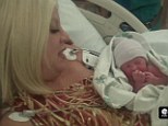 Their first cuddle: Tori Spelling holds baby Finn close to her chest moments after giving birth last August in a new video she posted to her blog