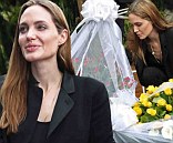 Sombre Angelina Jolie is in a reflective mood as she lays down flowers at memorial to victims of Rwanda genocide