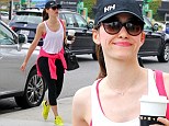 Emmy Rossum picks up a cup of coffee and pays her parking meter before heading into an office building in Brentwood, California