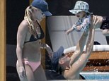 Her bundle of joy! Molly Sims can't help but keep her eyes on her baby son Brooks as she and husband Scott mark Easter weekend in Mexico