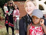 Hometown glory: Madonna takes her adopted children David and Mercy to visit their native Malawi
