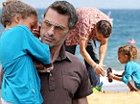 He's a natural at this! Doting Olivier Martinez enjoys playtime on the sand with Nahla before carrying sleepy girl home 