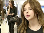 She's a tough cookie! Chloe Moretz travels to Los Angeles in Kick-Ass black leggings and rugged boots