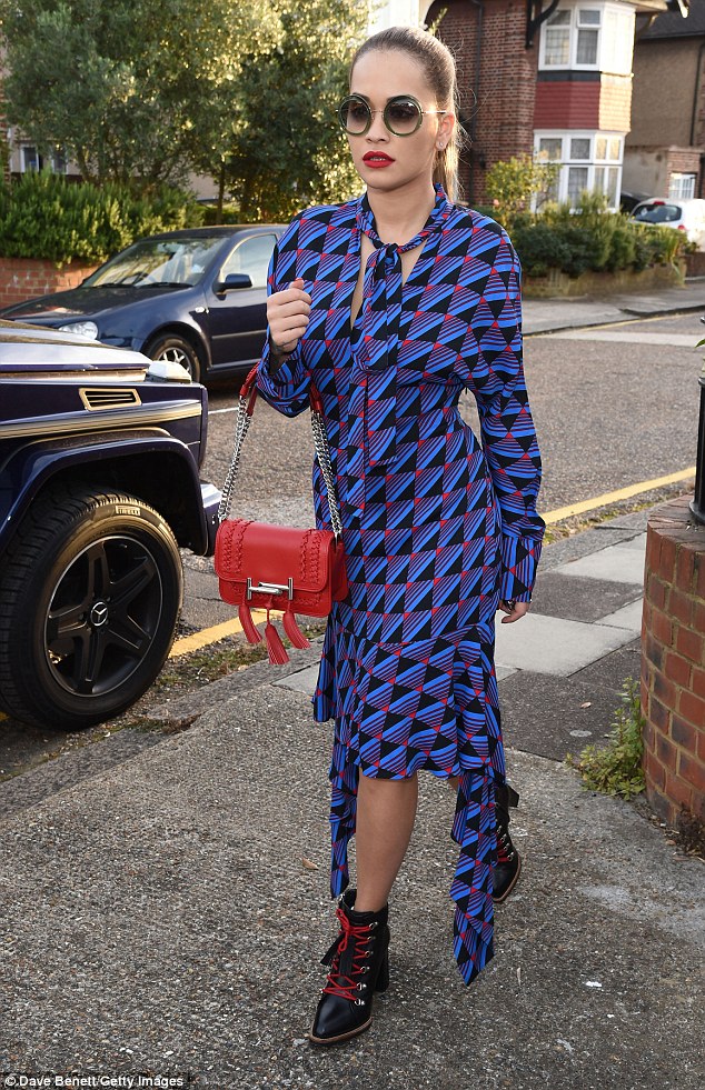 Bold in blue: Rita looked incredibly glamorous in a vibrant blue and black dress and ankle boots as she took a day off from the recording studio in London on Friday