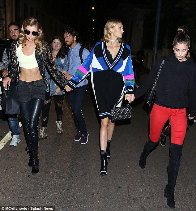 Squad goals: The 25-year stunned in the abs flaunting yellow number as she was joined by her fellow Victoria's Secret Angels Taylor Hill & Romee Strijd post-show - carrying a Dolce & Gabbana bag