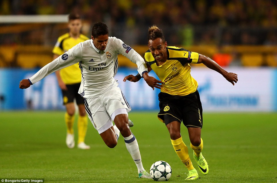 France and Real centre-backÂ Raphael Varane (left) tries to keep pace with Dortmund's dangerman Aubameyang