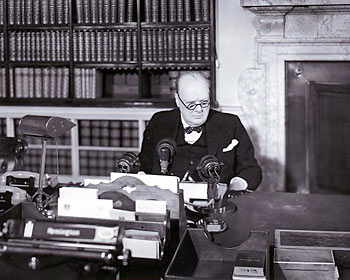Winston Churchill.A victorious Winston Churchill sits behind his microphone ready to make his speech to the nation on VE Day